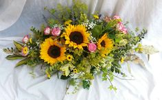 Large top table piece, sunflowers, roses, gypsophila and greenery